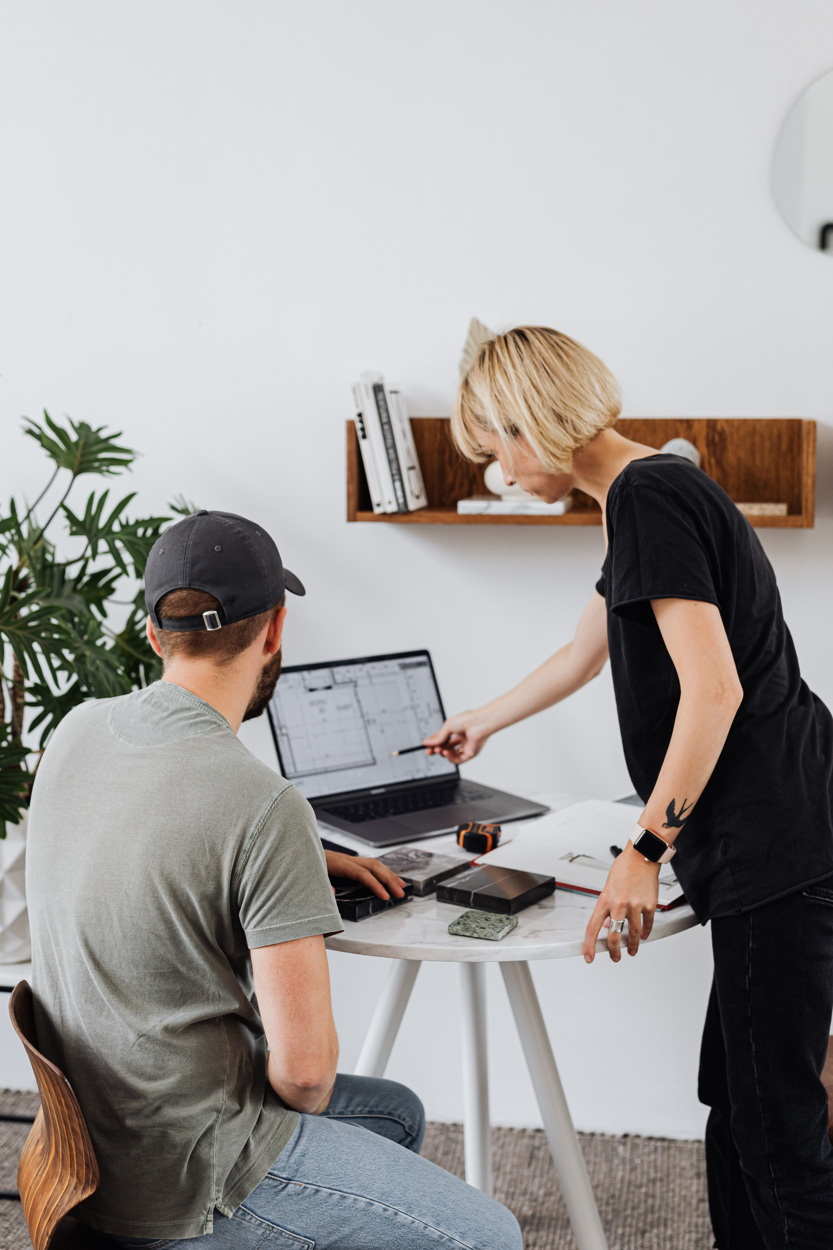 A sales representative walking an architect through a product on a laptop.