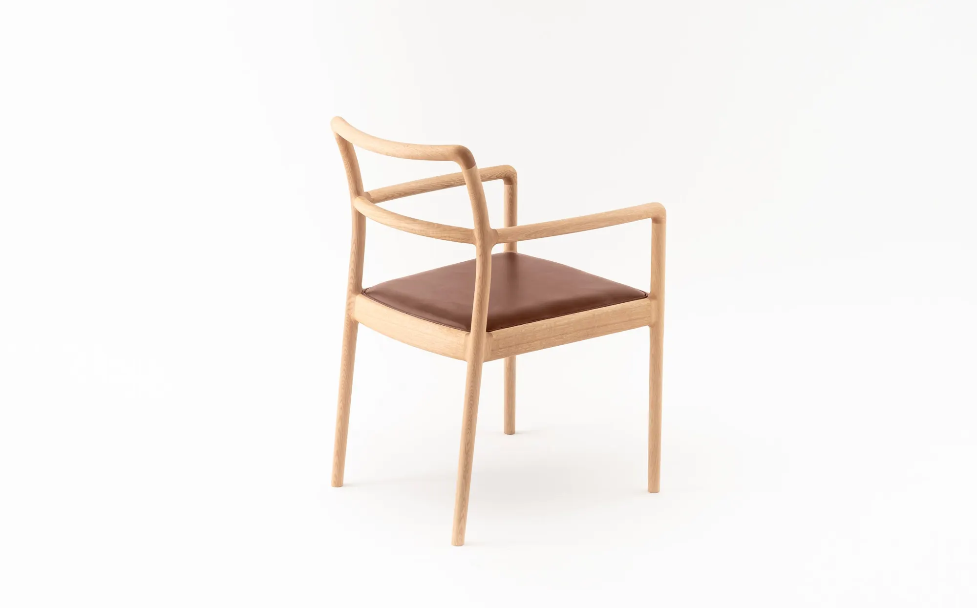 A discontinued wooden armchair with a leather seat.