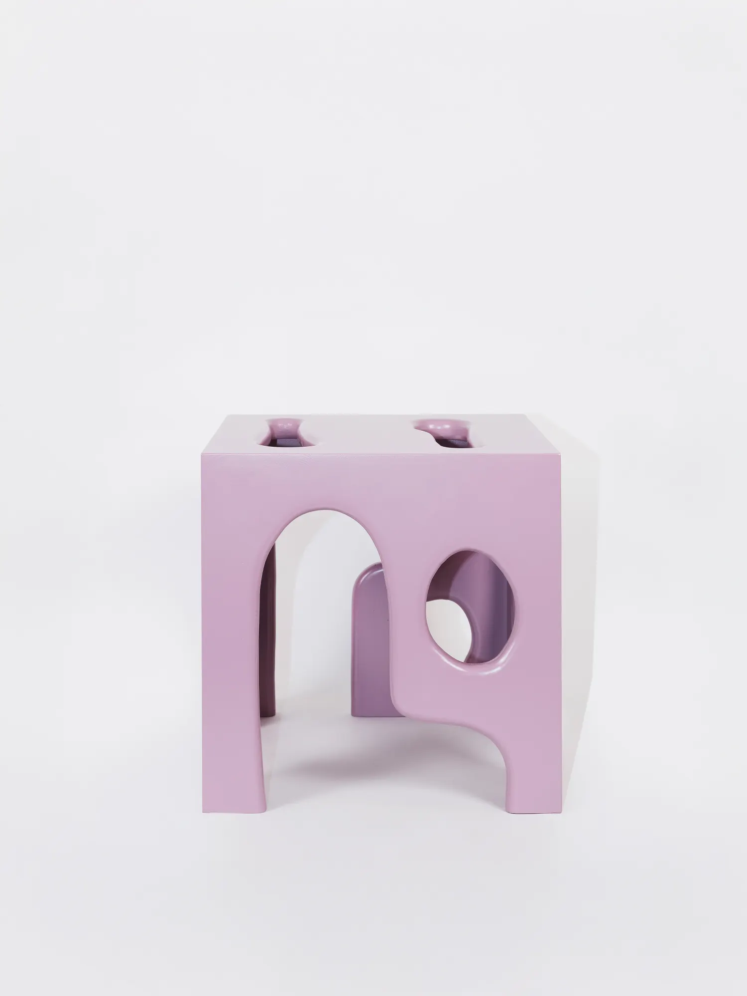 A pink prototype cabinet with cut-out arch details.