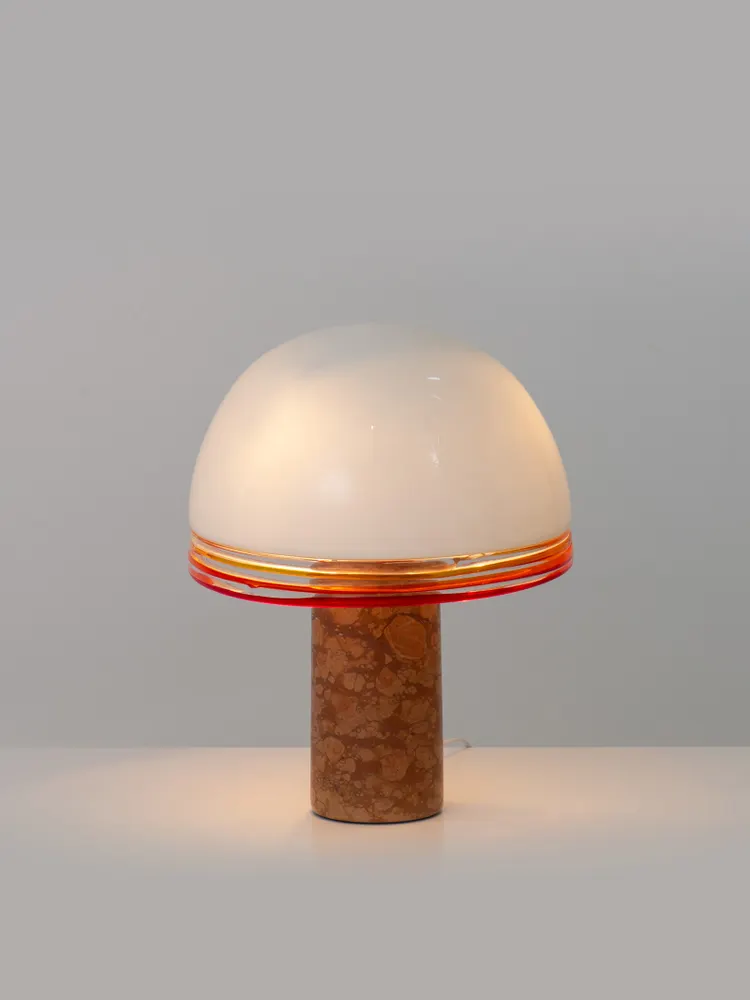 A vintage mushroom-shaped table lamp with a striped glass shade.